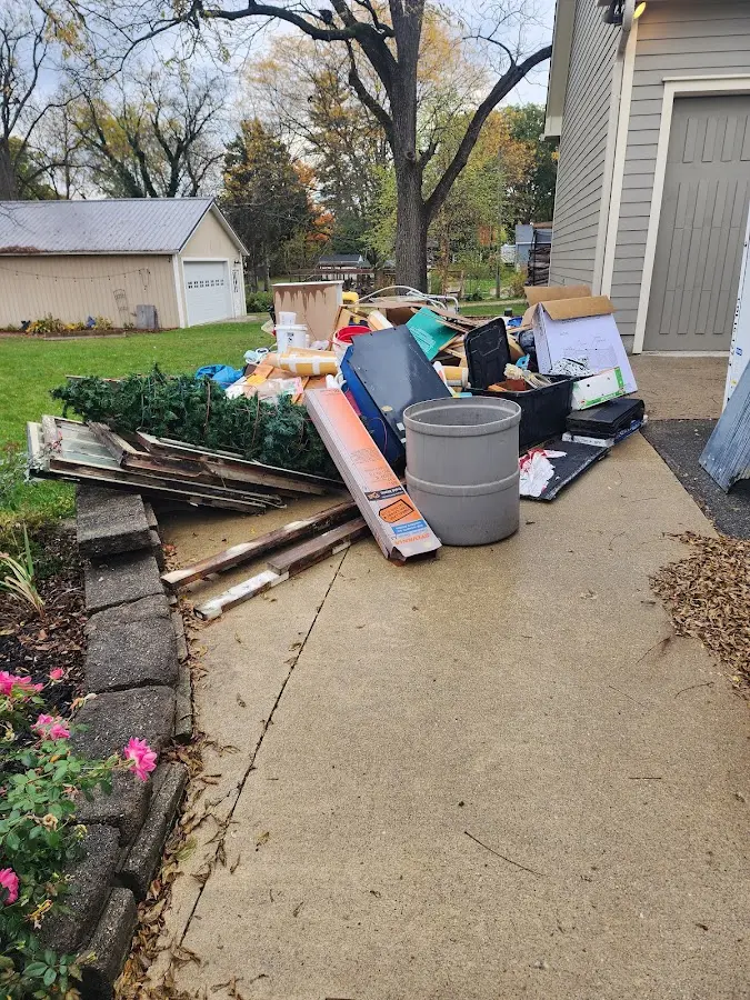 Dumpster being loaded with debris for 12 Yard Dumpster Rental in Fircrest